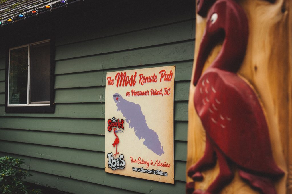 A sign on a building that says "The most remote pub on Vancouver Island"
