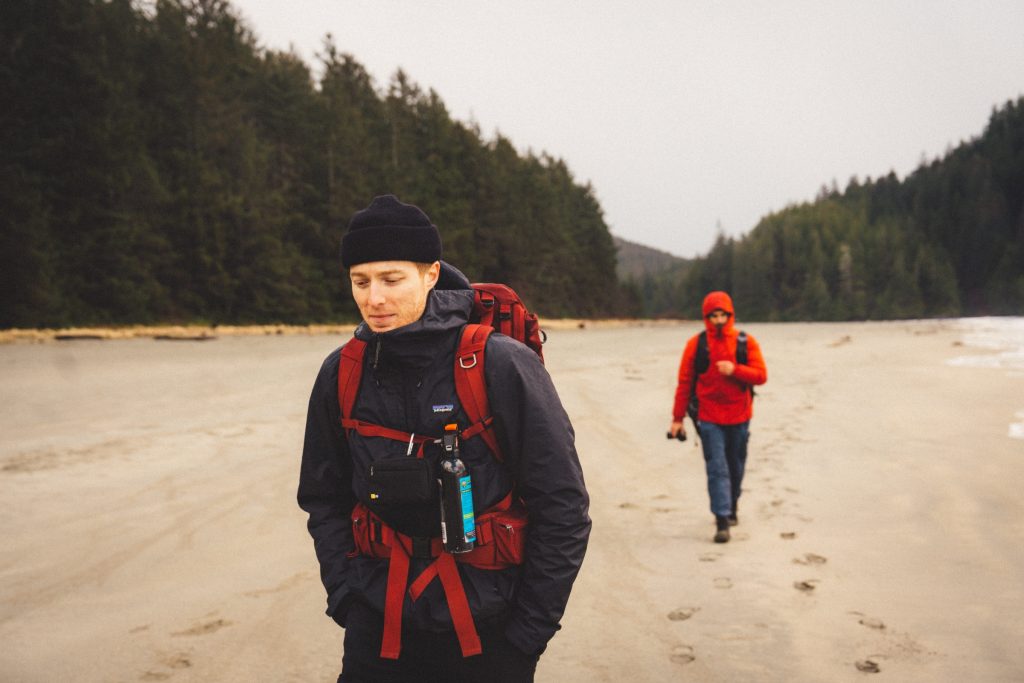 Two people walking on a remote beach