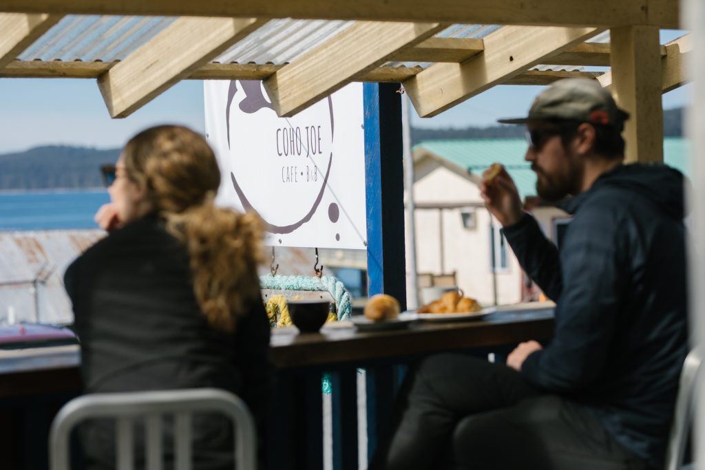 Two people having lunch overlooking the ocean